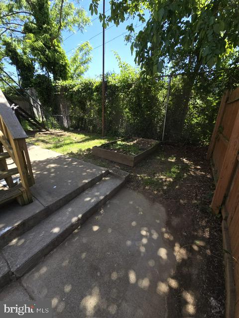 5314 Angora Terrace, Unit 1 Philadelphia, PA 19143 - Photo 15 of 15 a view of a yard with plants and tree