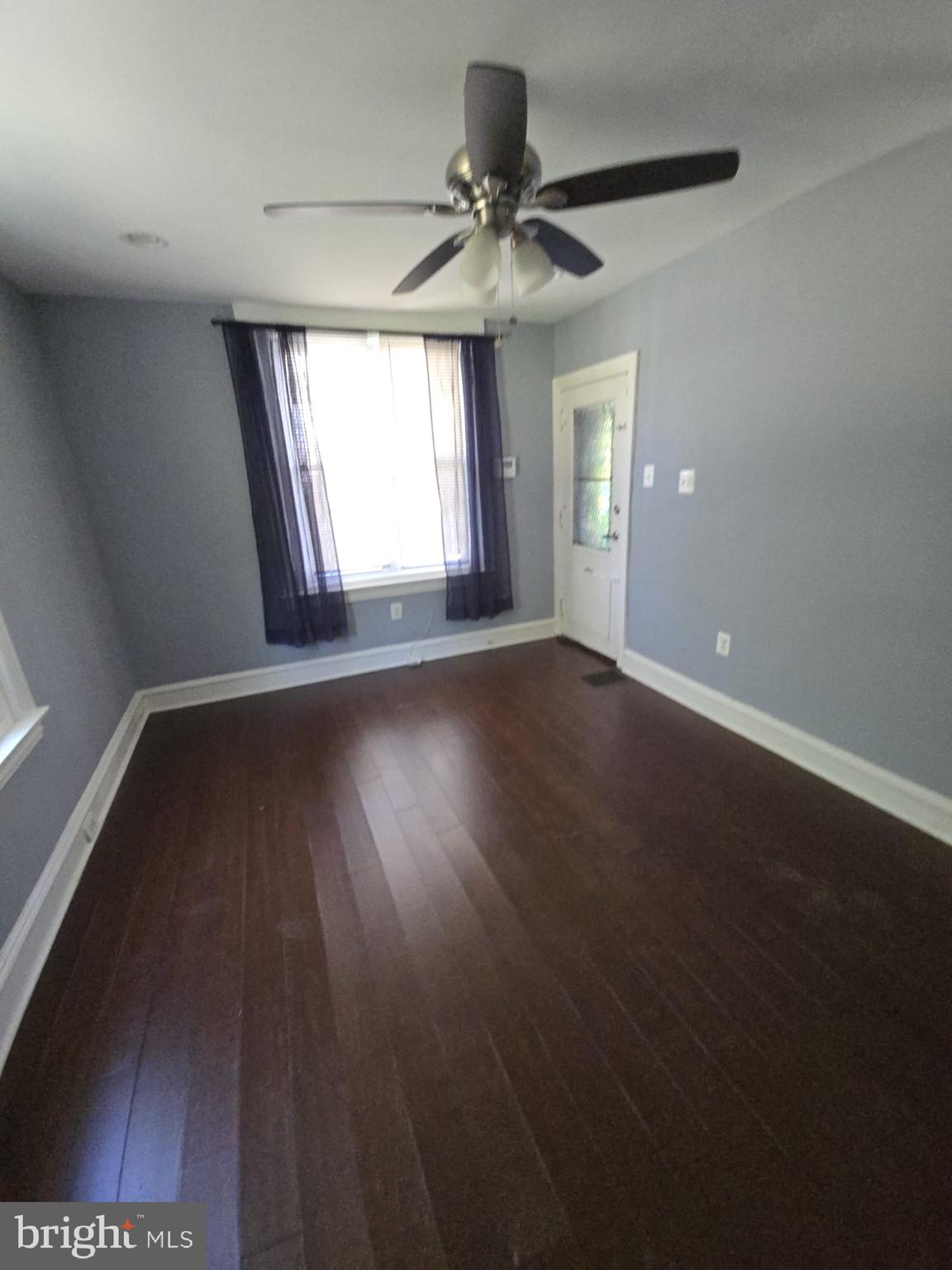 5314 Angora Terrace, Unit 1 Philadelphia, PA 19143 - Photo 3 of 15 a view of an empty room with a window and wooden floor