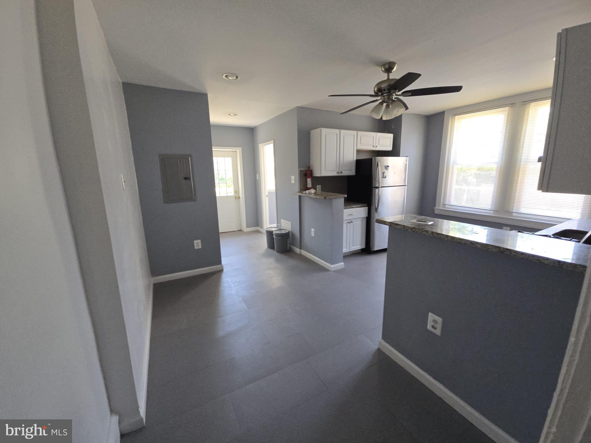 5314 Angora Terrace, Unit 1 Philadelphia, PA 19143 - Photo 9 of 15 a view of a kitchen with a sink a refrigerator a ceiling fan and wooden floor