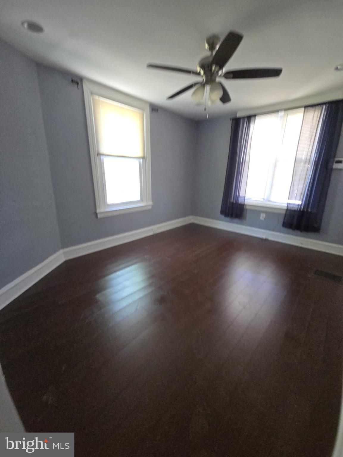 5314 Angora Terrace, Unit 1 Philadelphia, PA 19143 - Photo 10 of 15 a view of an empty room with wooden floor and a window