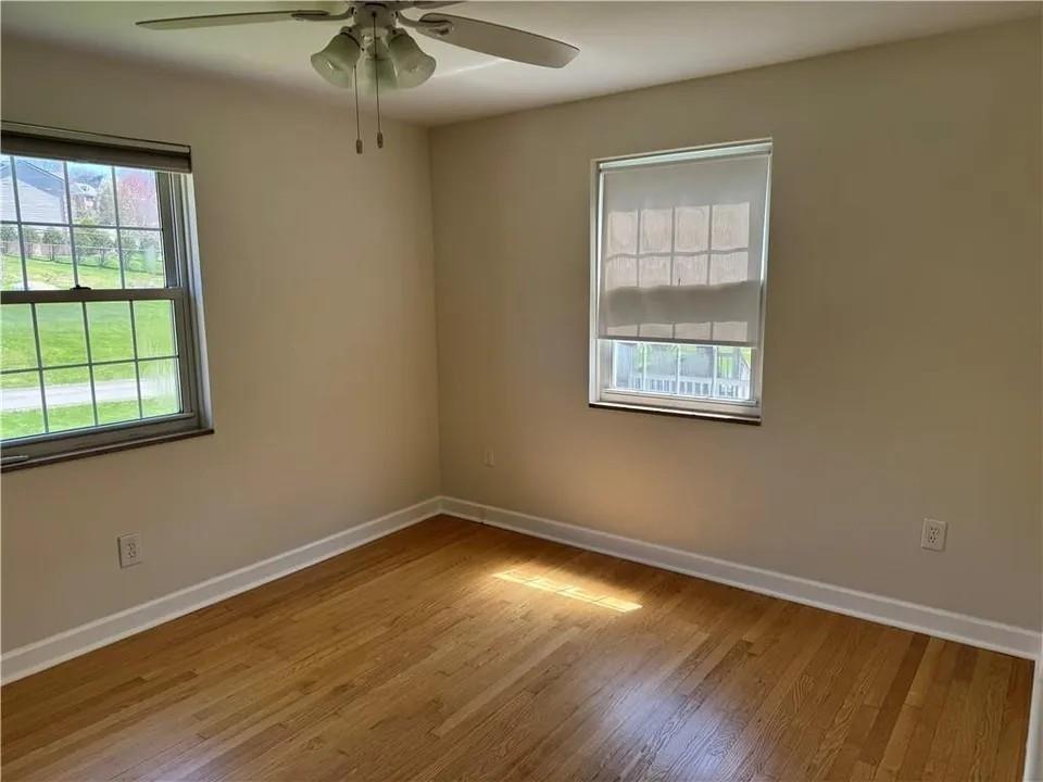 2251 Montgomery Road Sewickley, PA 15143 - Photo 18 of 36 an empty room with a window and wooden floor