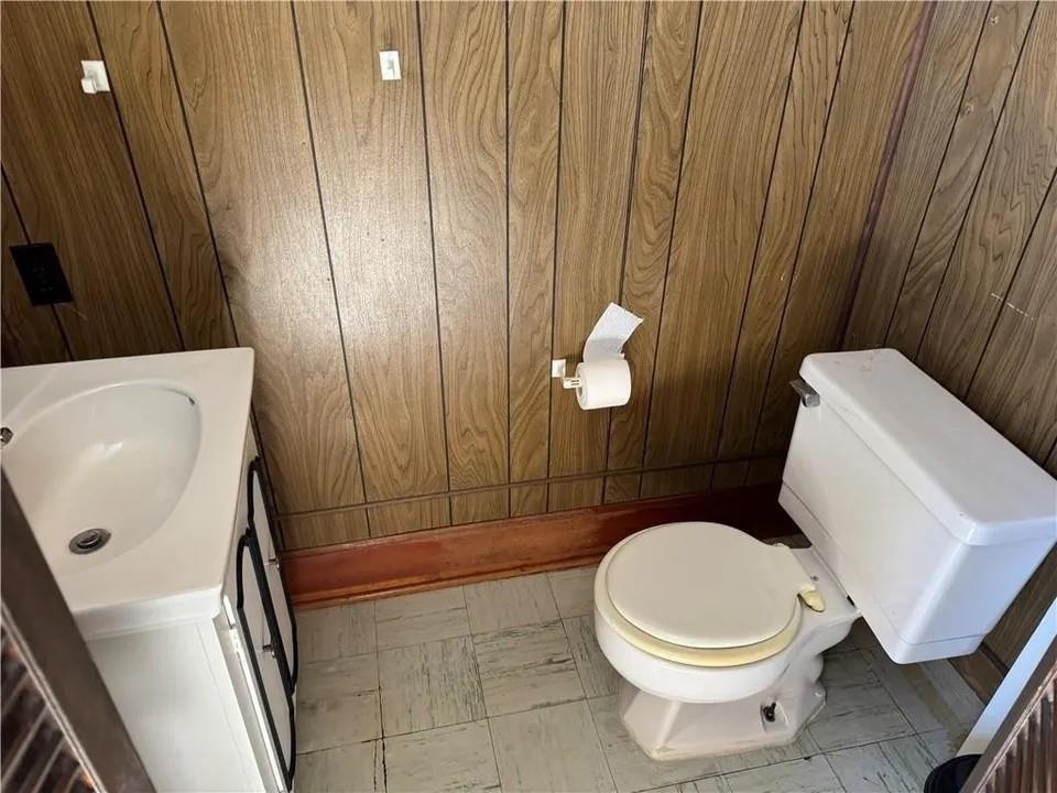 2251 Montgomery Road Sewickley, PA 15143 - Photo 28 of 36 a white toilet sitting next to a sink and vanity