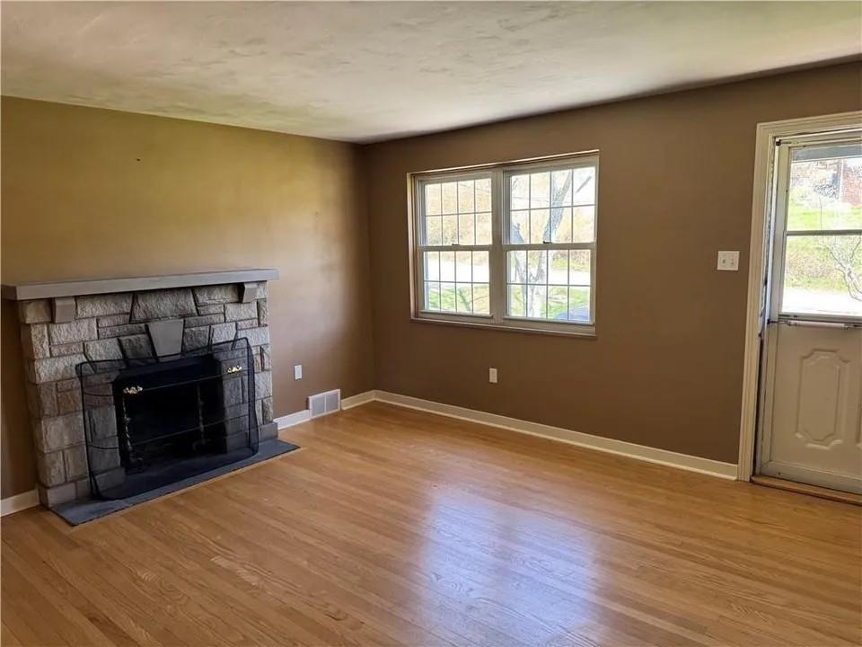 2251 Montgomery Road Sewickley, PA 15143 - Photo 4 of 36 an empty room with windows fire place and a fireplace