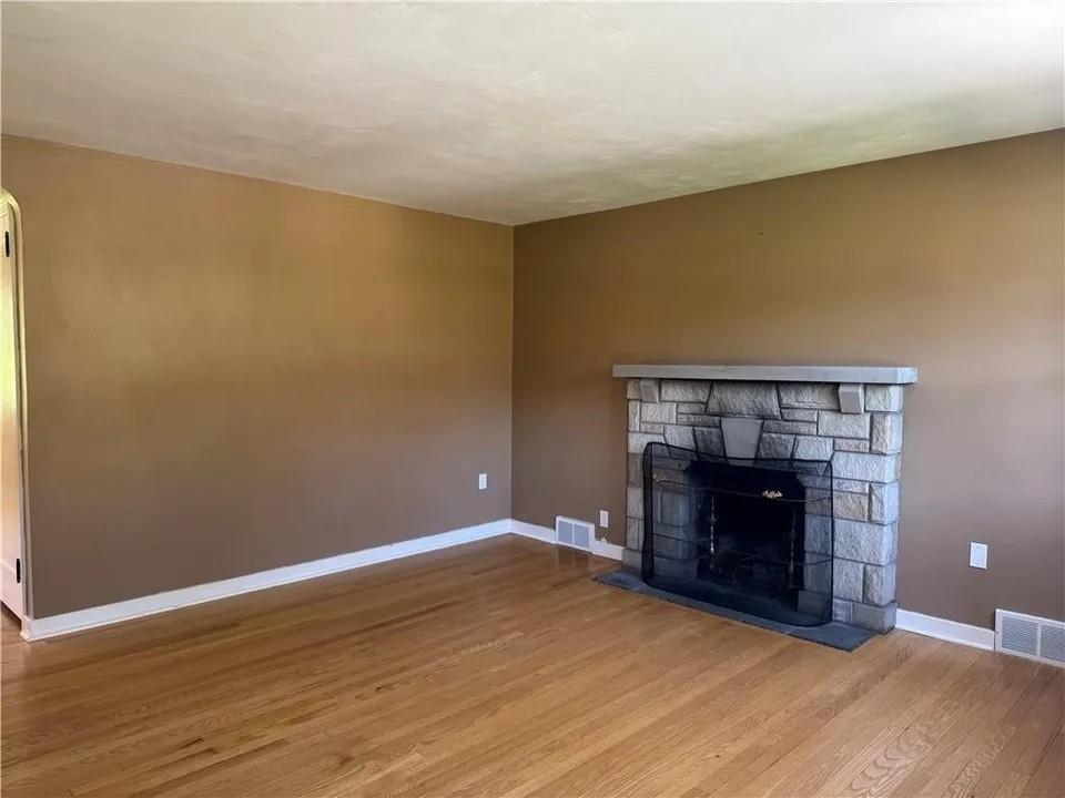 2251 Montgomery Road Sewickley, PA 15143 - Photo 5 of 36 a view of an empty room with wooden floor fireplace and a window
