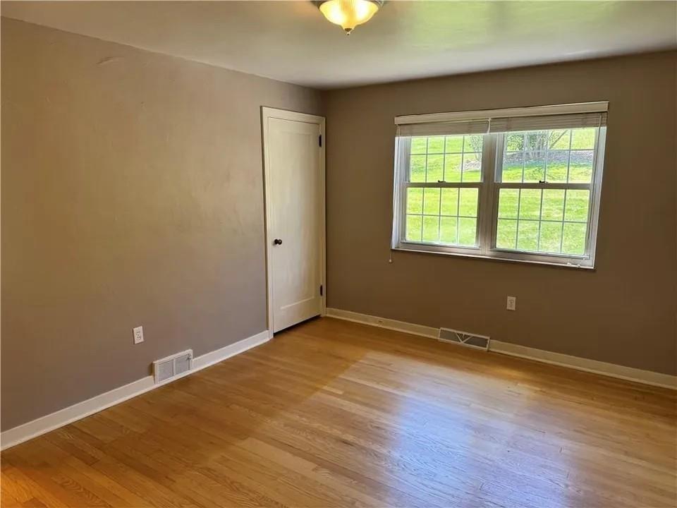 2251 Montgomery Road Sewickley, PA 15143 - Photo 7 of 36 an empty room with wooden floor and windows