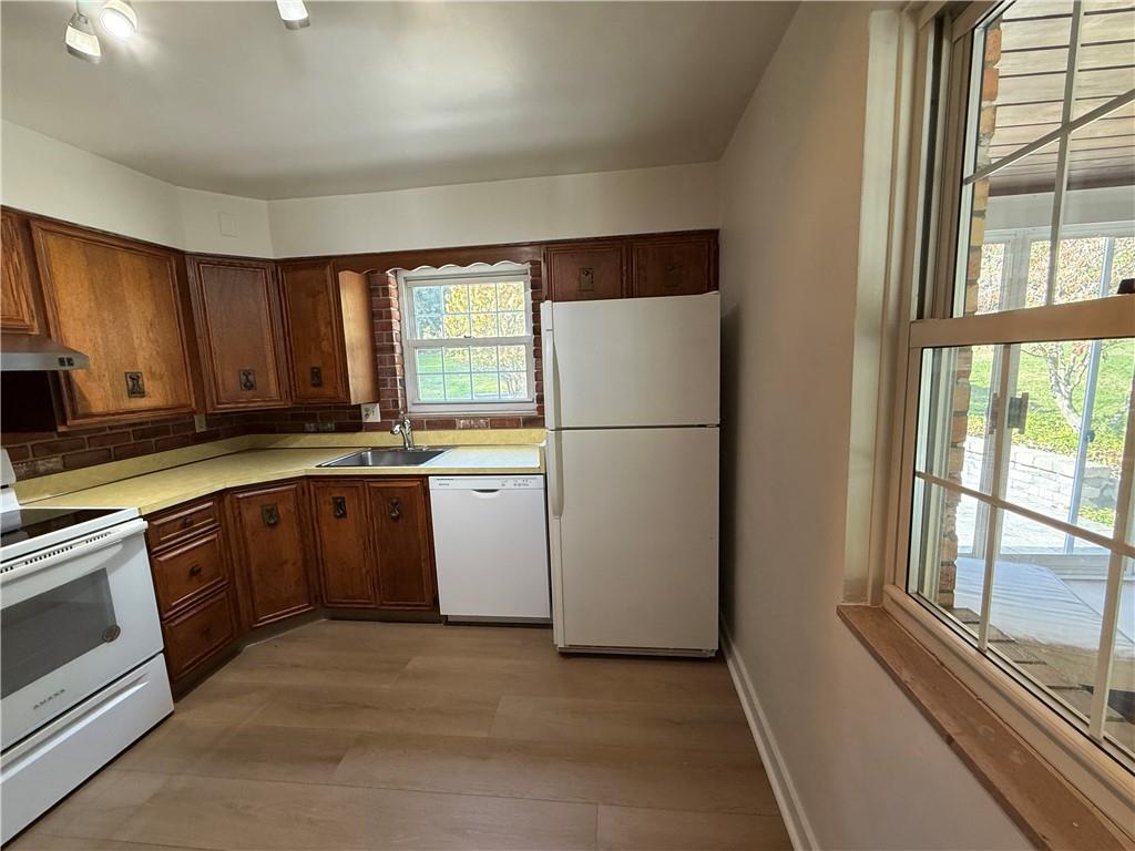 2251 Montgomery Road Sewickley, PA 15143 - Photo 10 of 36 a kitchen with a refrigerator sink and cabinets
