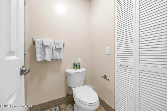 a white toilet sitting next to a white sink