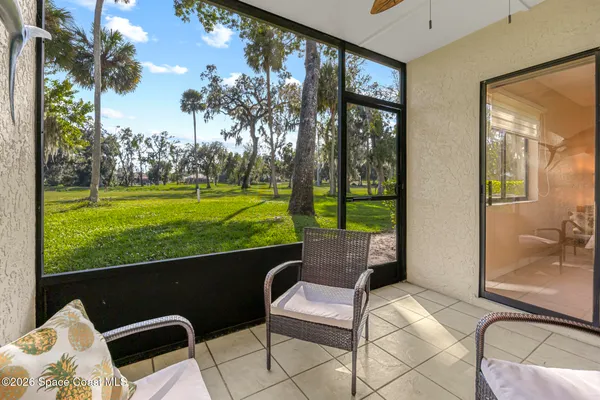 a balcony with table and chairs