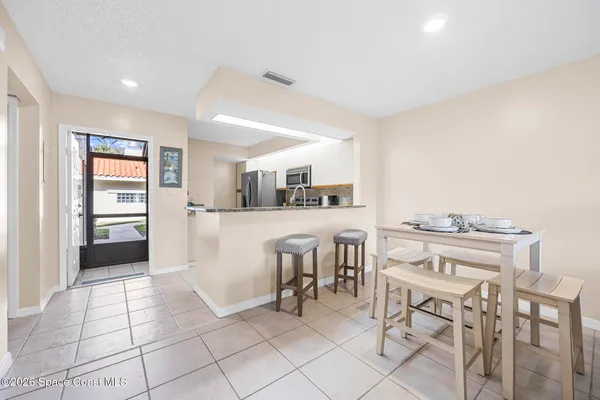 a kitchen with cabinets and chairs