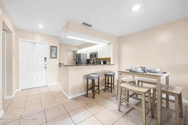 a kitchen with stainless steel appliances kitchen island granite countertop a refrigerator and a stove top oven