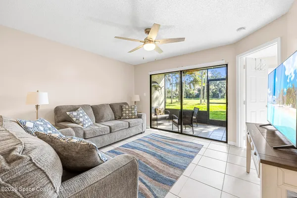 a living room with furniture and a floor to ceiling window