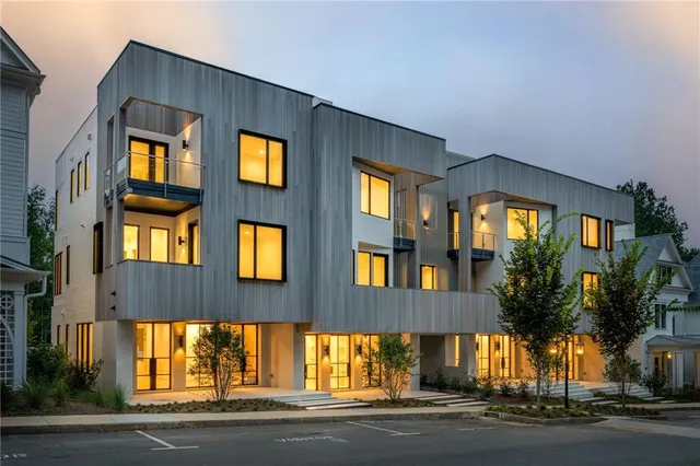 a view of brick house with a yard