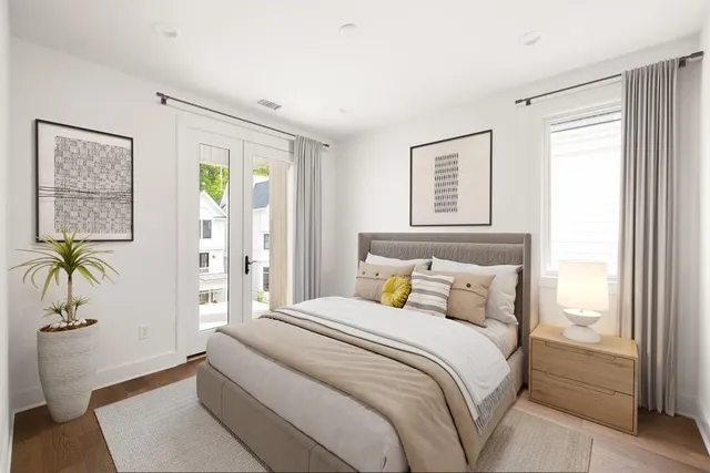 a bedroom with a bed and a potted plant