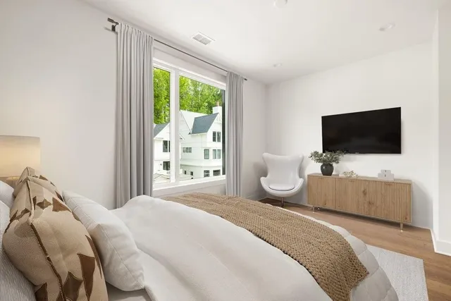 a bedroom with a bed and a flat screen tv