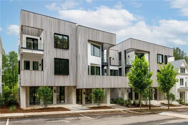 a front view of a building with a yard