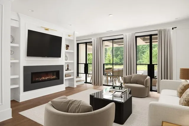 a living room with furniture fireplace and flat screen tv