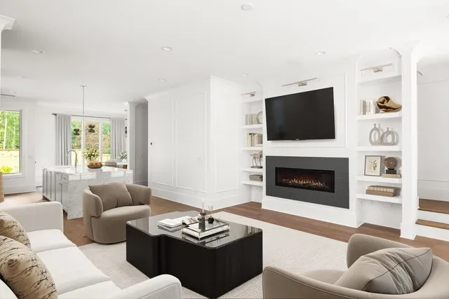 a living room with furniture a fireplace and a flat screen tv