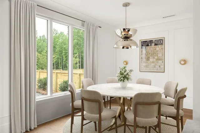 a dining room with furniture a chandelier and window