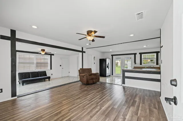 a living room with furniture and wooden floor