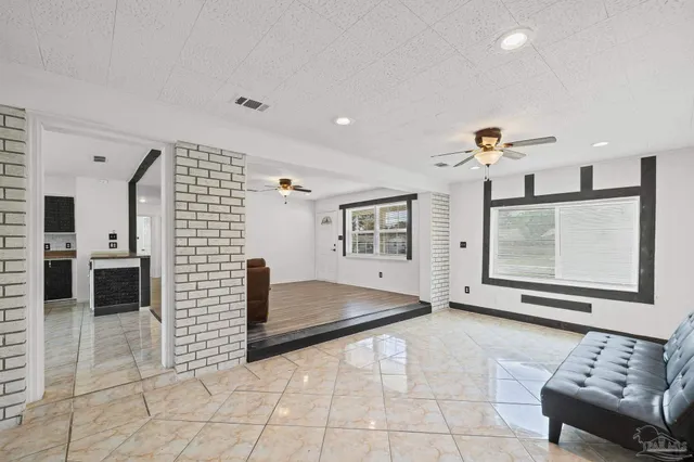 a view of a hallway with furniture and windows