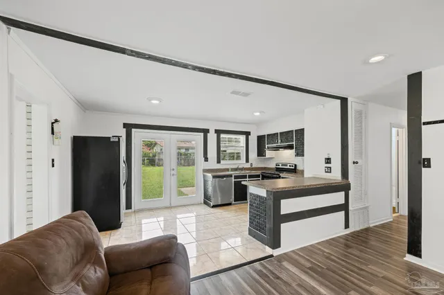 a living room with furniture and large windows