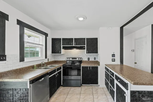a kitchen with stainless steel appliances granite countertop a stove and a sink