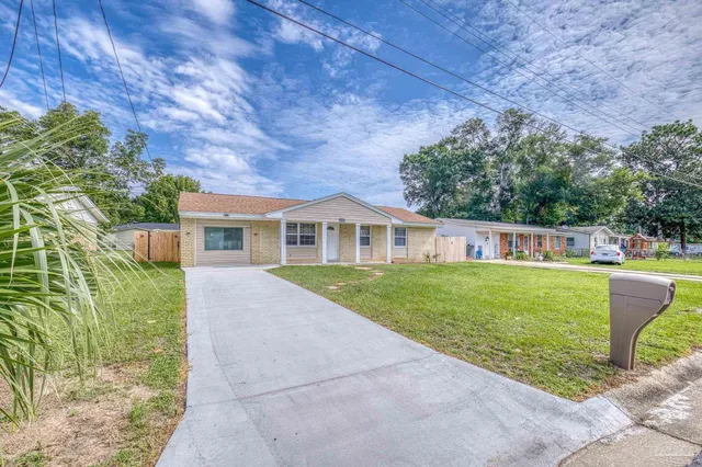 a front view of a house with a garden