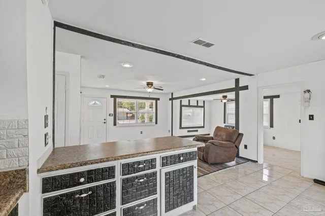 a living room with furniture a flat screen tv and couches