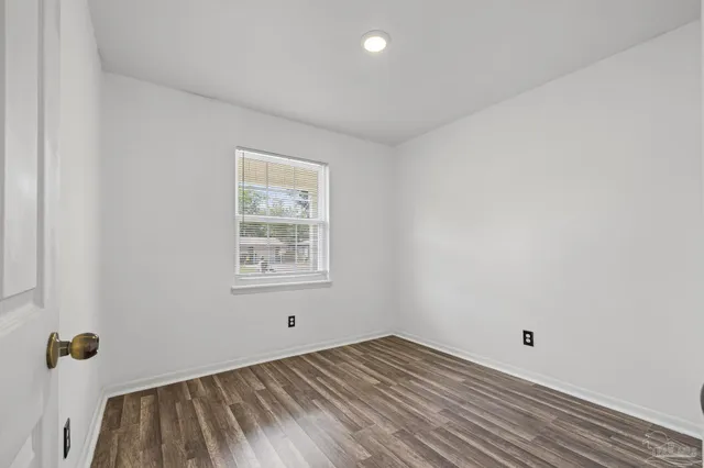 a view of a room with wooden floor and natural light