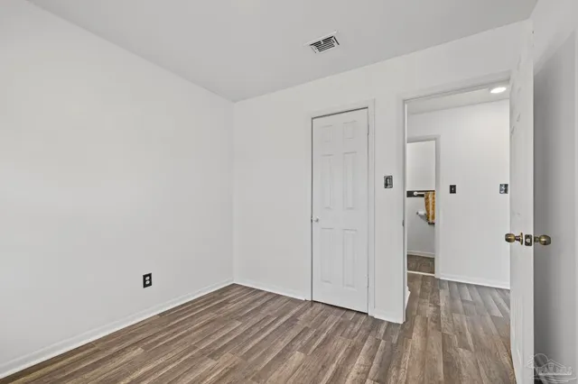 a view of a room with wooden floor