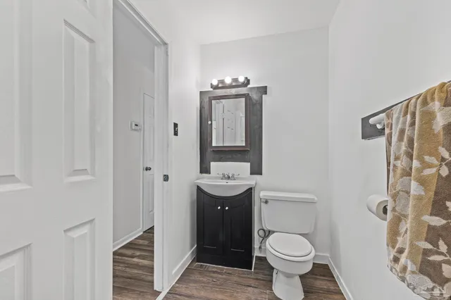 a bathroom with a toilet sink and mirror
