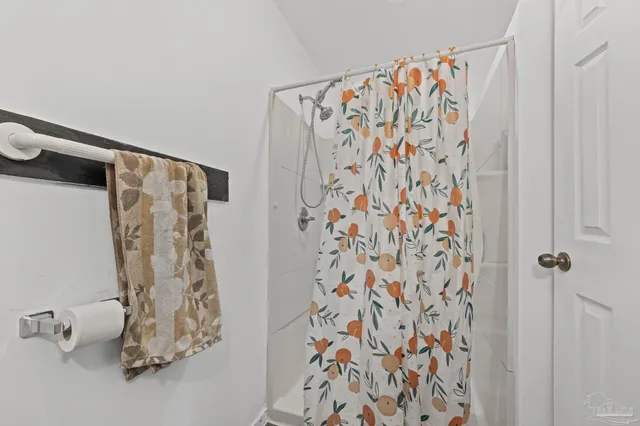 a bathroom with a shower curtain and a curtain