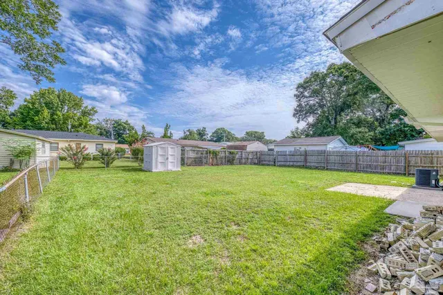 a view of yard with swimming pool and green space