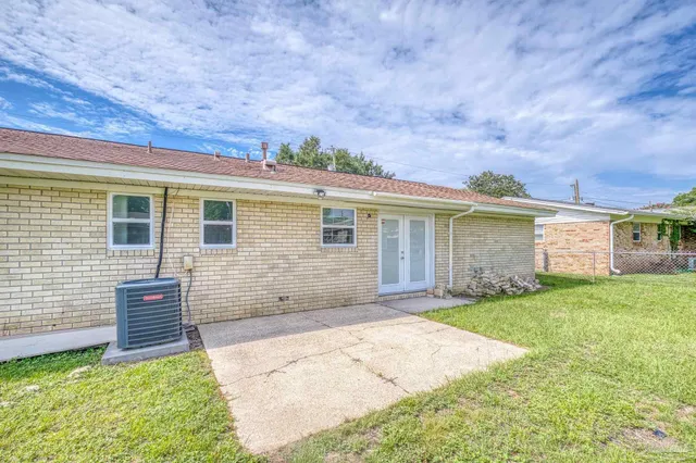 a backyard of a house with table and chairs