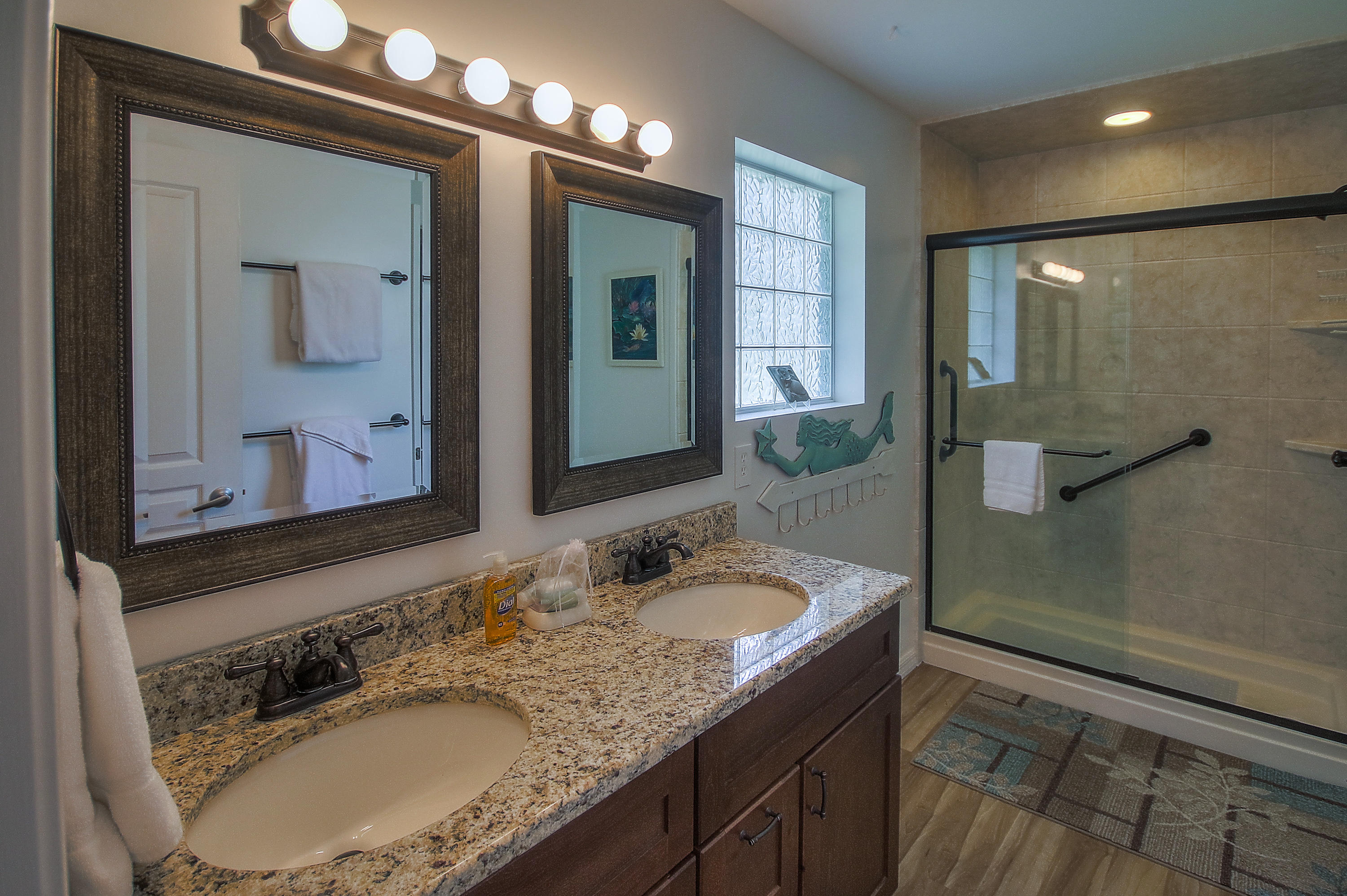 105 Garfield Street Santa Rosa Beach, FL 32459 - Photo 13 of 30 a bathroom with a granite countertop sink a mirror and a shower