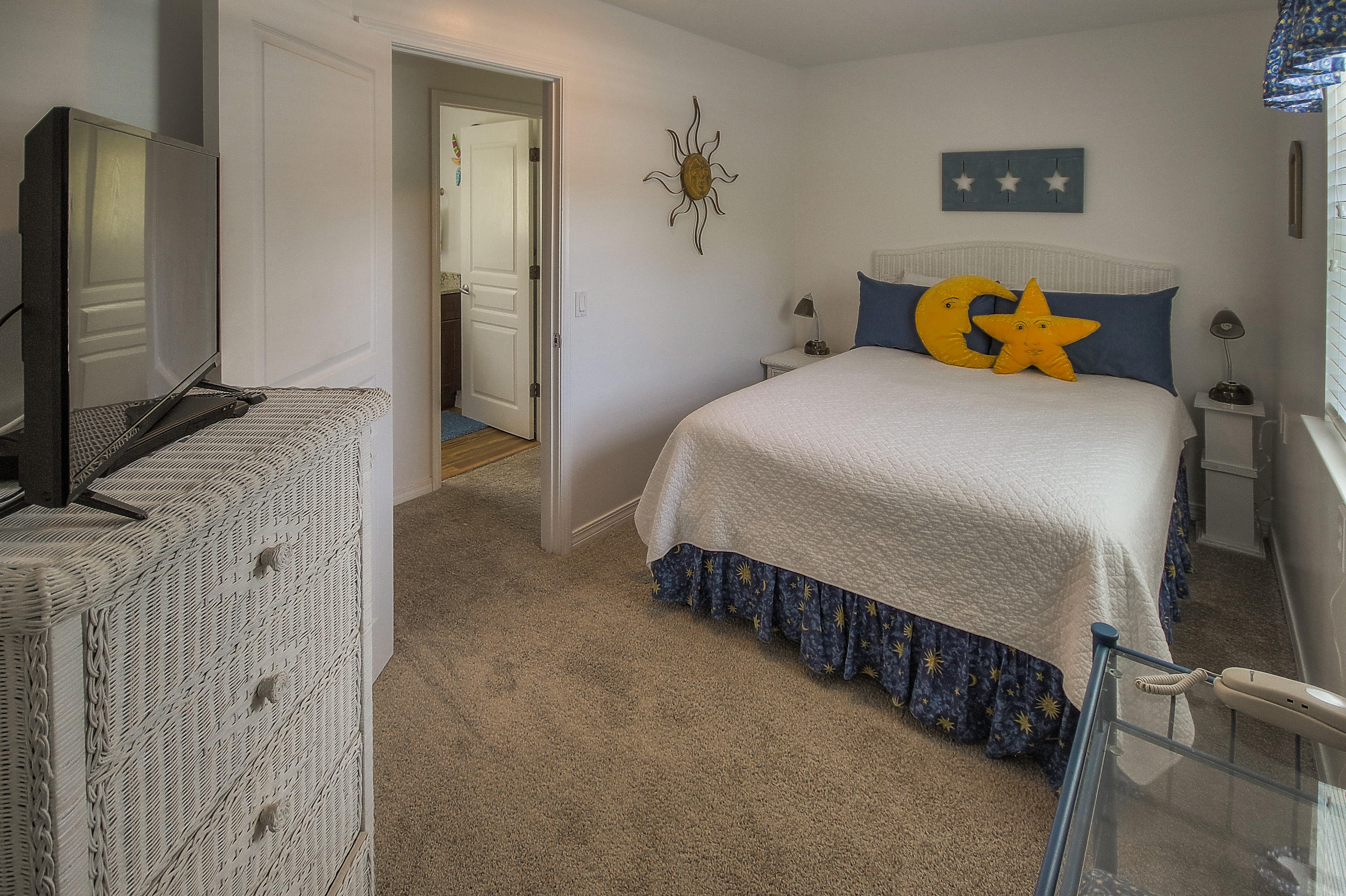105 Garfield Street Santa Rosa Beach, FL 32459 - Photo 16 of 30 a bedroom with a bed and a flat tv screen on dresser