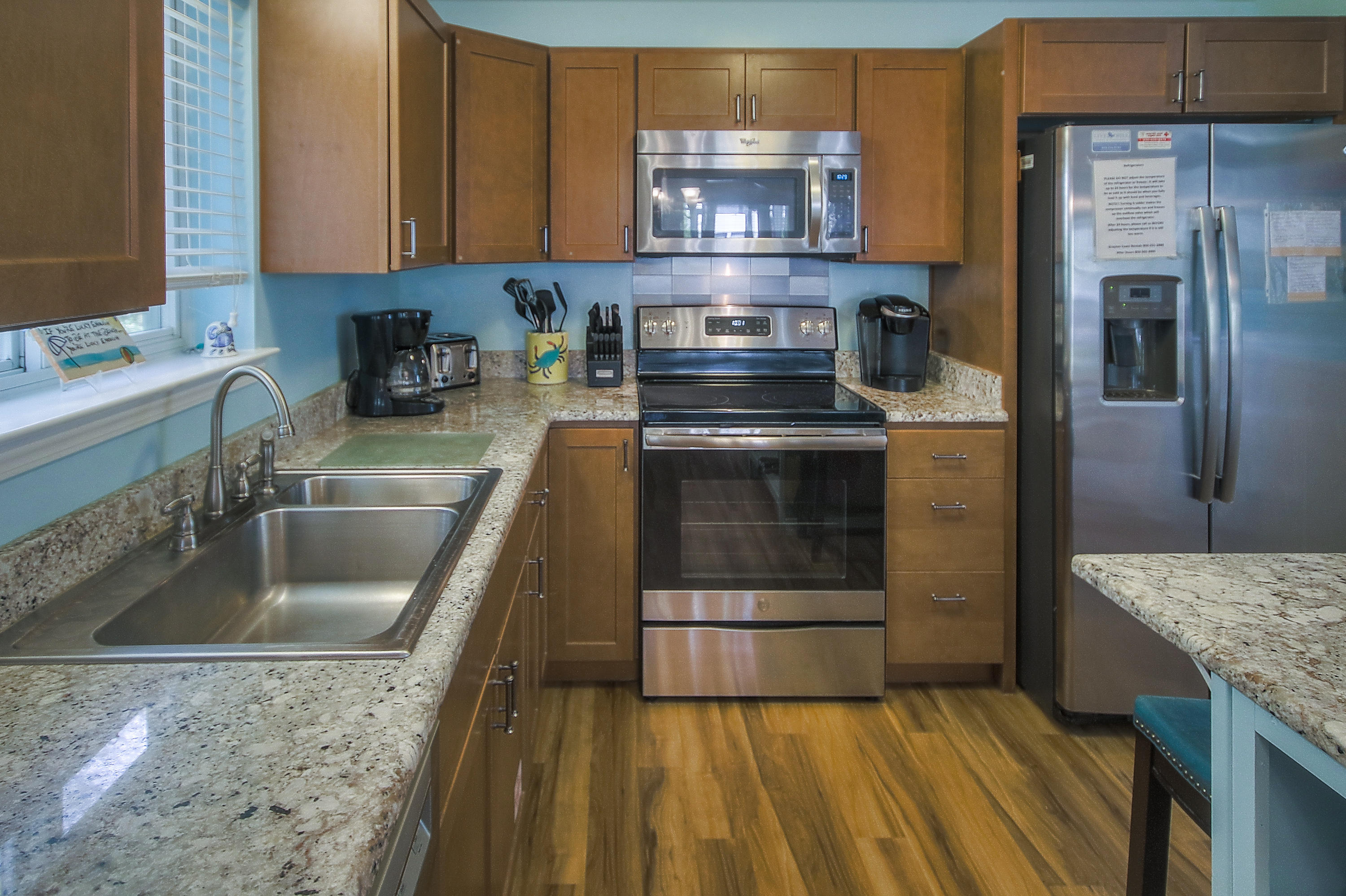 105 Garfield Street Santa Rosa Beach, FL 32459 - Photo 6 of 30 a kitchen with stainless steel appliances granite countertop a sink stove and refrigerator