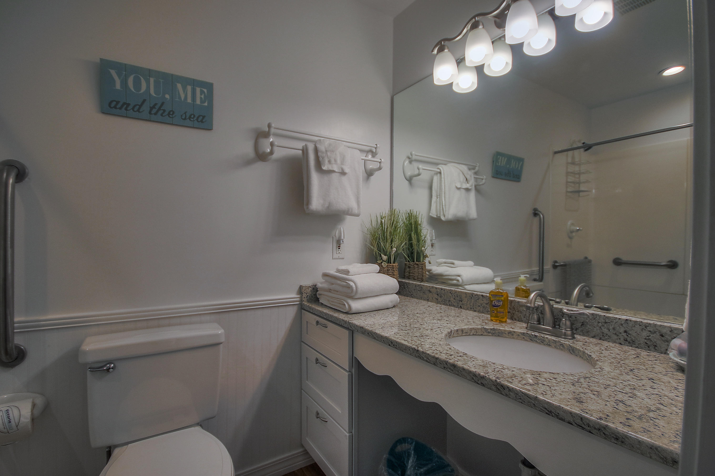 105 Garfield Street Santa Rosa Beach, FL 32459 - Photo 10 of 30 a bathroom with a granite countertop sink toilet a mirror and shower