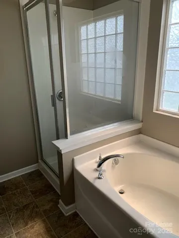 a bathroom with a tub and shower