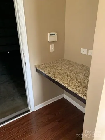 a view of an empty room and wooden floor