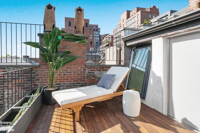 a view of a chairs and table in a backyard