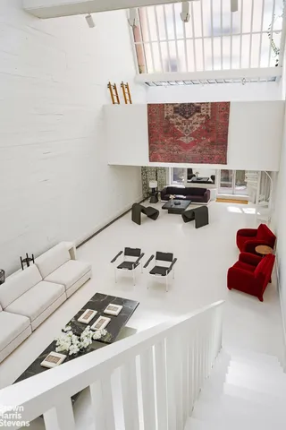 a living room with furniture and next to a window