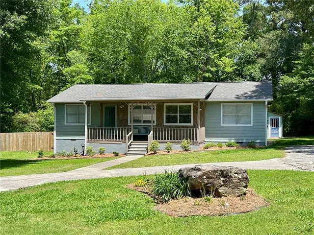 a front view of a house with a yard and porch