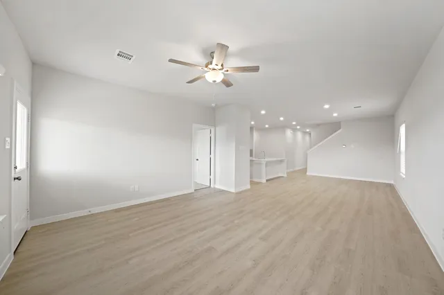 a view of an empty room with a ceiling fan
