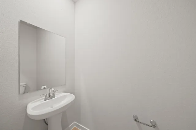 a bathroom with a sink a mirror and a toilet
