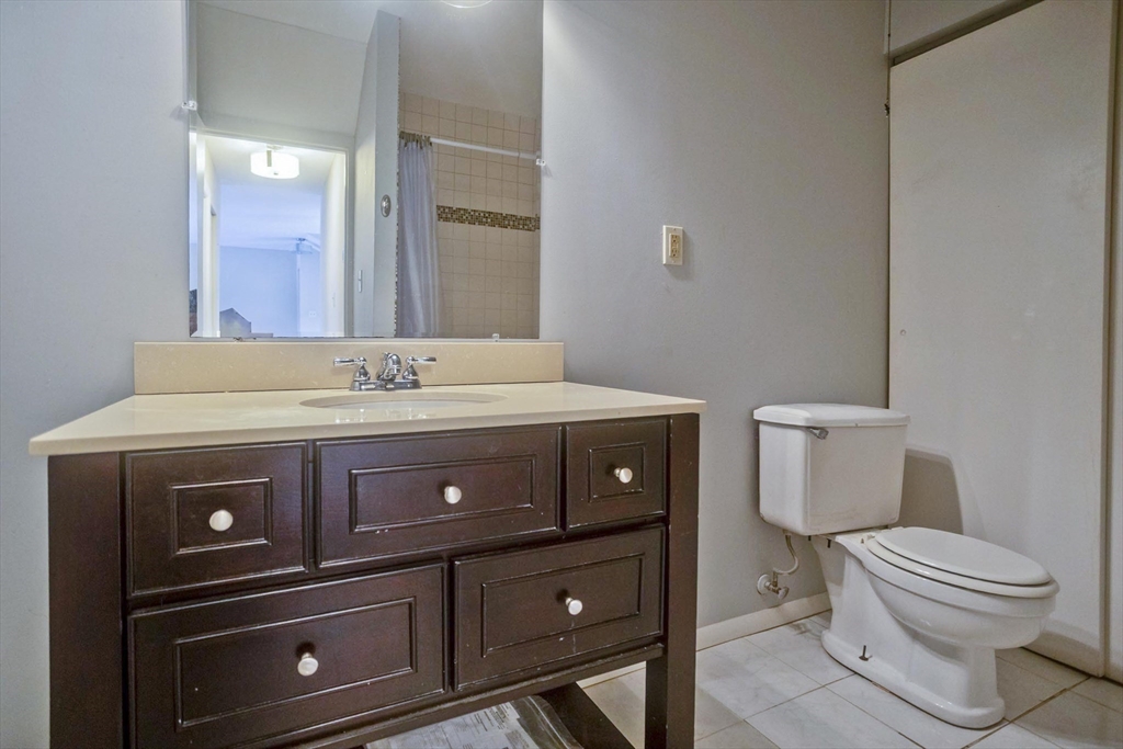 169 Nassau Drive, Unit 169 Springfield, MA 01129 - Photo 15 of 31 a bathroom with a sink a toilet and a mirror