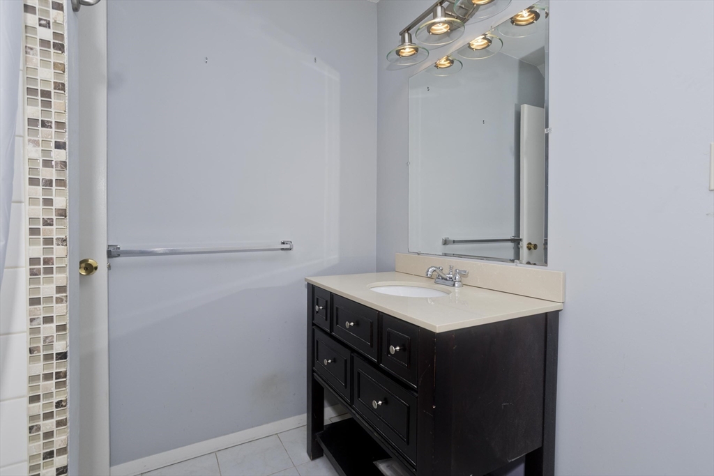 169 Nassau Drive, Unit 169 Springfield, MA 01129 - Photo 16 of 31 a bathroom with a sink and a mirror