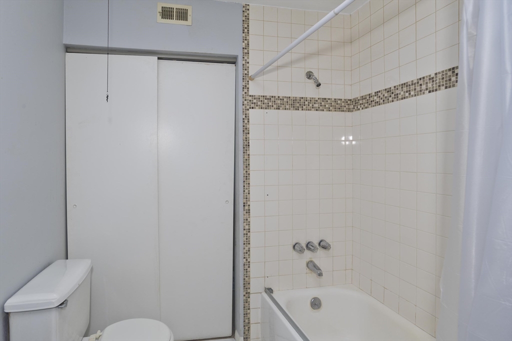 169 Nassau Drive, Unit 169 Springfield, MA 01129 - Photo 17 of 31 a bathroom with a bathtub a toilet and a shower