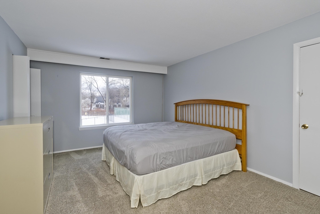 169 Nassau Drive, Unit 169 Springfield, MA 01129 - Photo 19 of 31 a bedroom with a bed and window