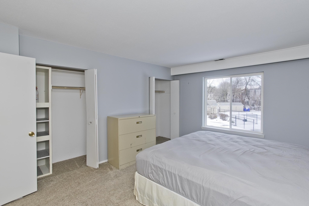 169 Nassau Drive, Unit 169 Springfield, MA 01129 - Photo 20 of 31 a bedroom with a bed and a window
